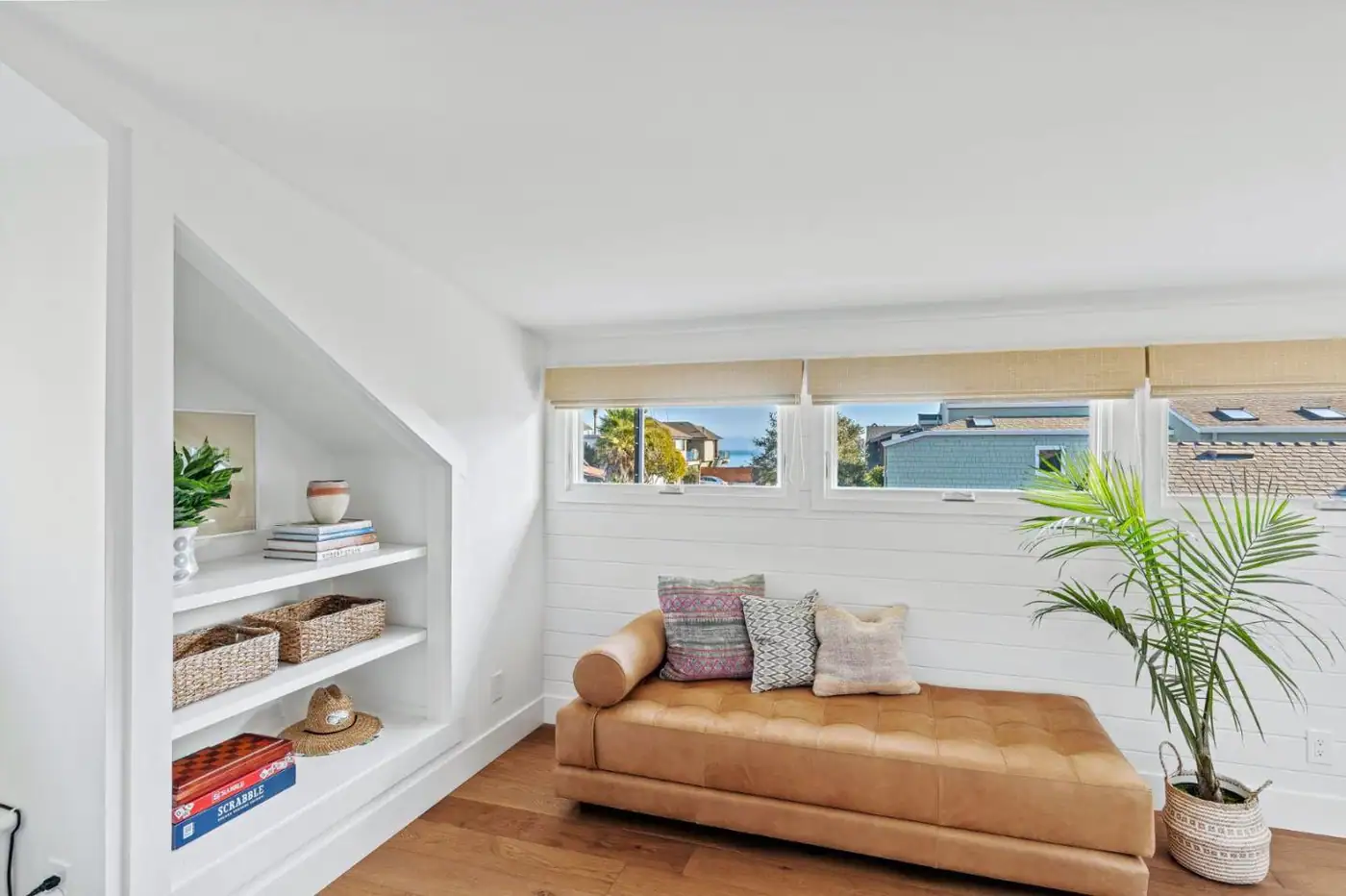 Upstairs room with built-in shelves, a row of windows and a leather daybed, Oakland Avenue project